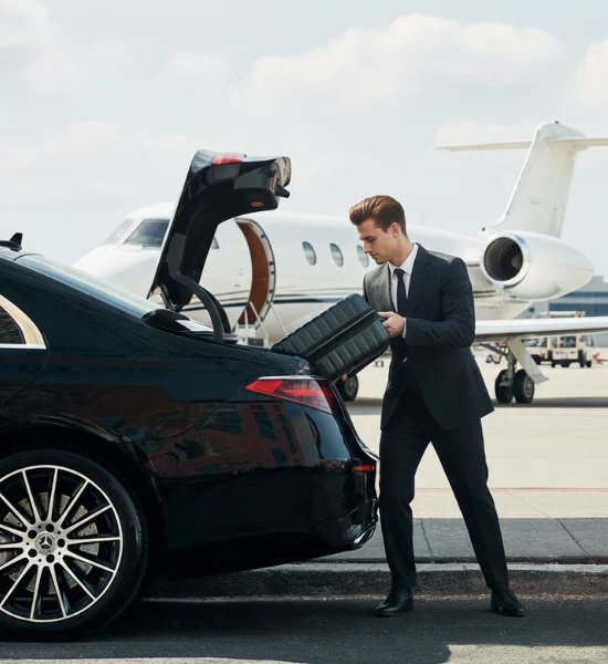 Chauffeur loading luggage at private jet terminal