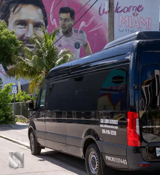 A black Mercedes Sprinter van parked on a Miami street in front of a colorful Welcome to Miami mural A black Mercedes Sprinter van parked on a Miami street in front of a colorful Welcome to Miami mural