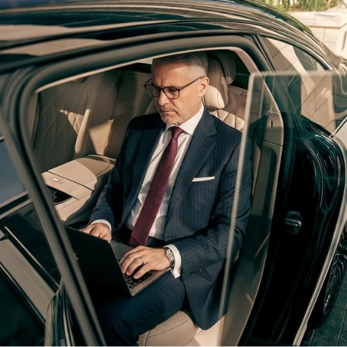 bal harbour businessman using laptop in luxury car bal harbour businessman using laptop in luxury car