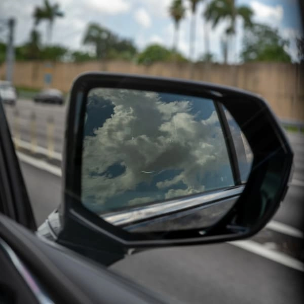 clouds reflected in a vehicle side mirror closeup clouds reflected in a vehicle side mirror closeup